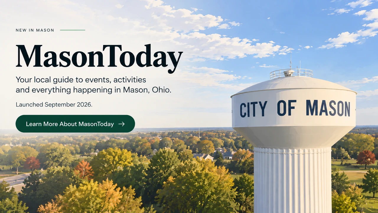 City of Mason water tower above autumn trees beneath a blue sky